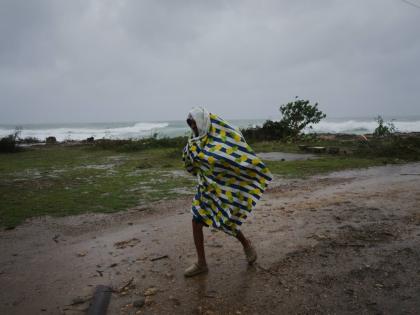A man walks in the rain before the arrival of Hurricane Melissa in Canizo, a village in Santiago de Cuba, Tuesday, October 28, 2025. (AP Photo/Ramón Espinosa)