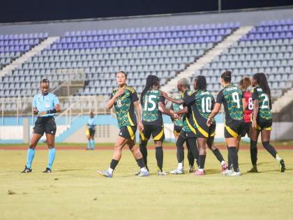 Jamaica’s Reggae Girlz celebrate one of the four goals they put past Trinidad and Tobago in a 4-1 win at the Ato Boldon Stadium on Tuesday. 