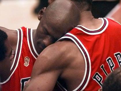 The Chicago Bulls’ Michael Jordan collapses in the arms of teammate Scottie Pippen (right) at the end of Game 5 of the NBA Finals against the Utah Jazz on June 11, 1997, in Salt Lake City. 