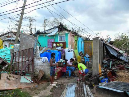 Residents of Cornwall Street in Falmouth, Trelawny, look at the damage done to their homes and possessions after the passage of Hurricane Melissa, which swept through the island on Tuesday.