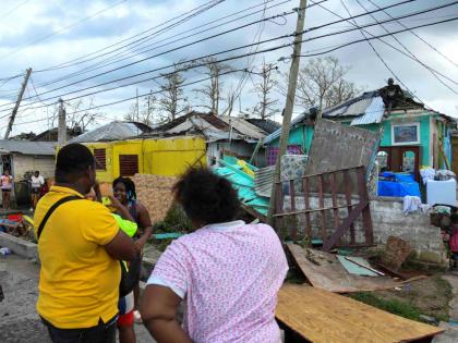 Residents of Cornwall Street, Compound in Trelawny look at the damage done to their homes after the passage of Hurricane Melissa, which swept through the island on October 28.