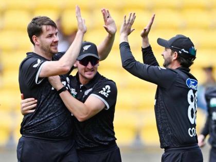
Jacob Duffy (left), Nathan Smith and Devon Conway of New Zealand celebrate the wicket of joe Root during the One Day International cricket match in Wellington, New Zealand, yesterday.