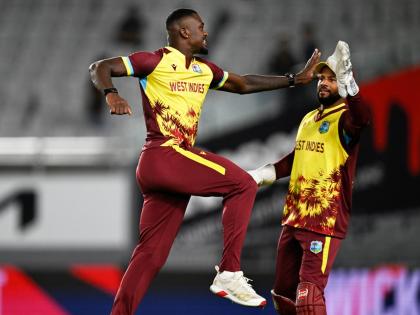West Indies bowler Jayden Seales (left) celebrates with skipper, Shai Hope after taking the wicket of New Zealand’s Michael Bracewell during the first T20 International between the teams at Eden Park in Auckland, New Zealand, on November 5.
