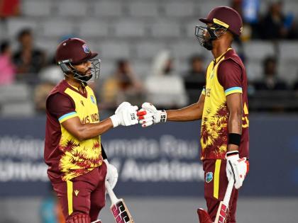 West Indies’ captain Shai Hope (left) and Roston Chase bump fists after reaching a 50-run partnership during the first T20 International cricket match of a five-game series against New Zealand, at Eden Park in Auckland, New Zealand yesterday.