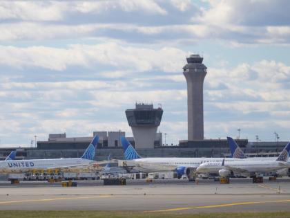 Planes are seen in front of an air traffic control tower at Newark International Airport in Newark, N.J., Thursday, November 6, 2025. (AP Photo/Seth Wenig)