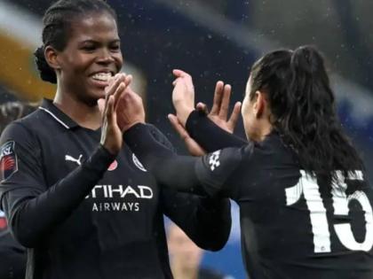Khadija Shaw (left) celebrates after scoring the winner for Manchester City against Everton yesterday.