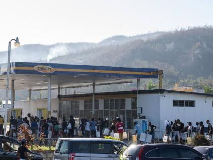 Dozens of people wait to purchase fuel from the Thrifty gas station along the Bogue road in Montego Bay, St James, on November 2. 