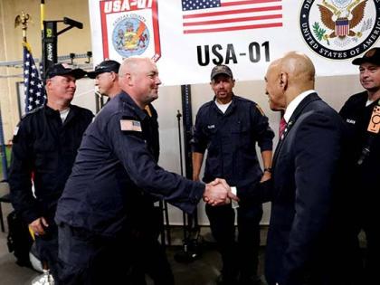 Jamaica’s Ambassador to the United States, Major General (Ret’d) Antony Anderson, greets a member of the Fairfax County Urban Search and Rescue team.