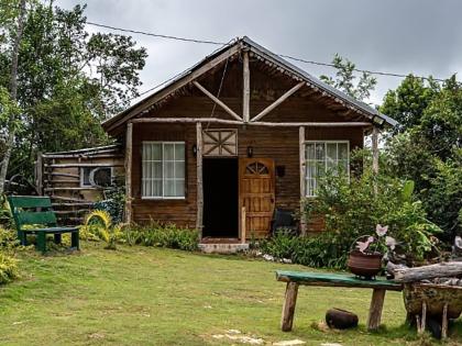 left: The rustic timber cottage in St Elizabeth, photographed in better days. 