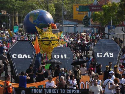 Climate activists protest with coffins that read coal, oil and gas during the COP30 UN Climate Summit, Saturday, November 15, 2025, in Belem, Brazil. (AP Photo/Andre Penner)
