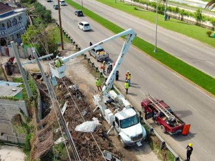 Lineworkers from Jamaica and overseas in Montego Bay on Sunday.
