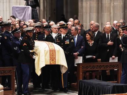 Former Presidents front row from left, George W Bush with Laura Bush and Joe Biden with Jill Biden, look on as military pall bearers arrive with the casket of former Vice President Dick Cheney at the Washington National Cathedral, Thursday, November 20, 20