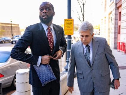 Prakazrel Pras Michel, a member of the 1990s hip-hop group the Fugees, accompanied by defence lawyer David Kenner (right), arrives at federal court April 3, 2023, in Washington.