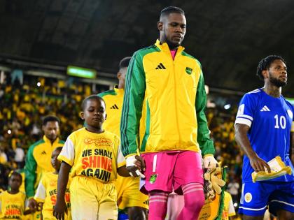 Reggae Boyz captain Andre Blake (left) leads his team out ahead of last Tuesday’s final Concacaf Group B World Cup Qualifying match at the National Stadium. Jamaica drew 0-0 with Curacao and failed to earn an automatic spot in the 2026 World Cup. 