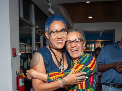 SiiM (left) shares a smile as media personality Fae Ellington warmly embraces her in celebration of her big moment.