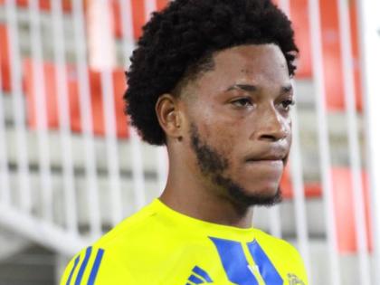 Mount Pleasant goalscorer Kimoni Bailey gets ready to enter the fray at the Estadio Cibao in the Dominican Republic yesterday. Bailey scored the only goal of the first leg of the Caribbean Cup final against Universidad O&M. 
