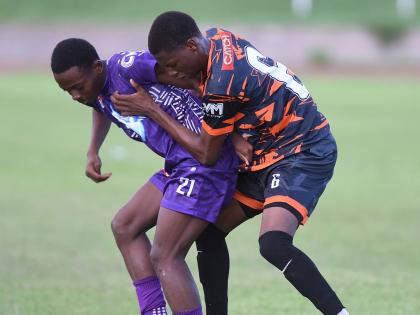 Robinho Morgan (left) of Kingston College and Horace Morgan of Tivoli High battle for the ball during their ISSA-WATA Manning Cup football match at the Stadium East field on on Wednesday, October 1. KC won 4-0.
