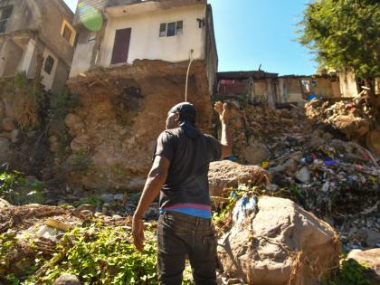 Mark Jackson, a resident of Tavern, St Andrew, highlights the dangerous erosion caused by the swollen Hope River.