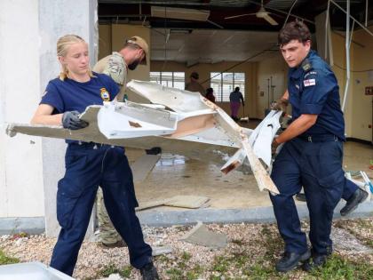 Specialist personnel from the Royal Navy’s HMS Trent assisting hospital workers clearing the debris at Falmouth Hospital in Trelawny.