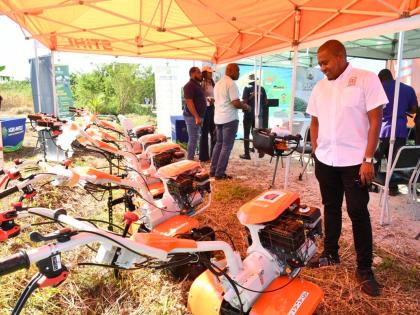 Minister of Agriculture, Fisheries and Mining, Floyd Green, surveys the walk-behind tractors and earth augers that were handed over in a ceremony on Wednesday,November 26, 2025, at the Amity Hall Agro-Park in St Catherine. The equipment will be distributed