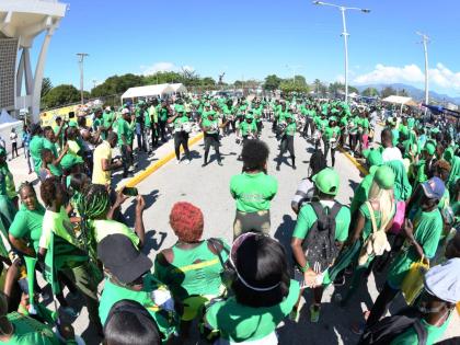 In this 2019 photo onlookers gather to watch the Mighter Flyers Marching Band perform outside the National Arena,  venue of the JLP Annual Conference.