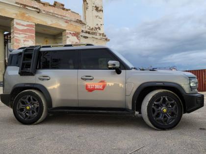 Defined profile view highlighting the purposeful square design and the practical utility of the optional external ladder and roof box.