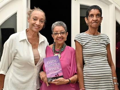 There’s no greater feeling than celebrating a sibling’s milestone, with first-time author Sandra D. Cooper (centre) flanked by her sisters, Celia McCreath (left), and Sherille Hamilton.