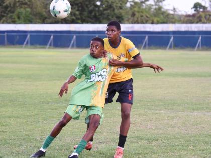 Ocho Rios High School’s Shamari Linton shields the ball from York Castle High’s Rushawn Coke (back) during their Zone K football match in the ISSA daCosta Cup competition at Drax Hall Sports Complex on Tuesday, October 7.