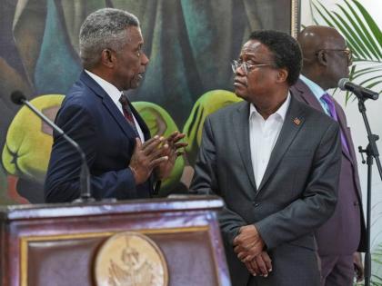 Chief of Protocol of the National Palace Marc Marie Yves Mazile speaks to Fritz Alphonse Jean, a member of Haiti’s transitional presidential council, before the start of a press conference in Port-au-Prince, Haiti on November 25, 2025. 