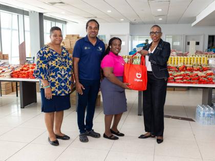 Digicel Foundation Chair, Joy Clark (right), presents a relief care package to representatives from Ready to Sign, Deaf Sports Jamaica, and the Jamaica Deaf Youth Advocacy as part of their donation drive to support members of the deaf community with much-n