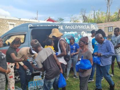 Residents of Chatham, St James, collect care packages and bottled water during the RG CARES outreach in St James on November 23, part of the foundation’s continuing relief efforts following Hurricane Melissa.