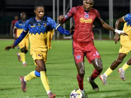 Montego Bay United’s Lucas Lima Correa (right) tries to dribble away from Racing United’s Tameish Richardson during their Jamaica Premier League match at the Catherine Hall Sports Complex in Montego Bay on October 19. 
