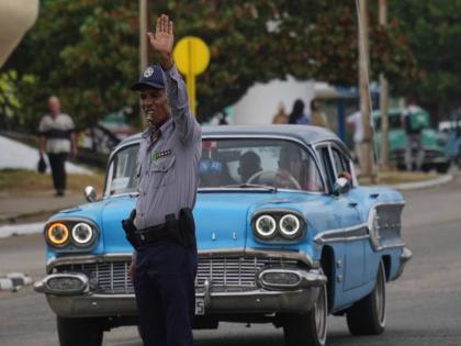 A National Police officer directs traffic due to a power outage in Havana, Cuba, Wednesday, December 3, 2025.
