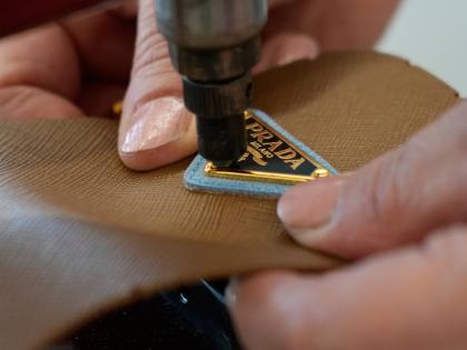 A leather good operator works at the Prada factory in Scandicci, Italy.
