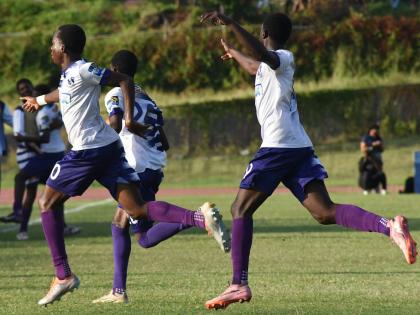 Kingston College’s players react after scoring against Calabar High during their Manning Cup football match  at the National Stadium East field on Wednesday. The game ended in a 2-2 draw.