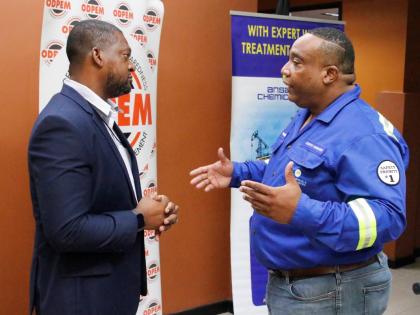 Commander Alvin Gayle, director general of the Office of Disaster Preparedness and Emergency Management (ODPEM) converses with Stephen Summers, country manager of Ansa Chemicals Jamaica, at the relief support handover at the ODPEM.