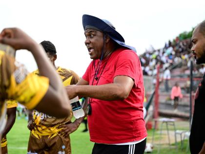 Charlie Smith coach Eugene Williams remonstrates with his charges during an ISSA/WATA Manning Cup fixture.