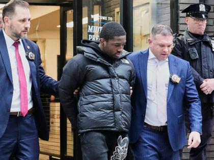Frederick Green, 20, (second left) of The Bronx borough of New York, charged with attempted murder in the shooting of New York Jets’ player Kris Boyd, is escorted from the Midtown South Police Precinct, in New York yesterday.