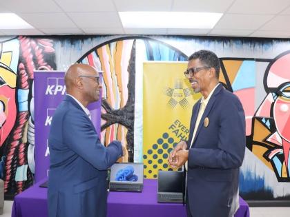 Raymond Campbell (left), 0ffice manager partner at KPMG in Jamaica and country leader for KPMG in CARICOM, shares a light moment with Ian Neita, chair of Project STAR’s Management, Monitoring and Reporting Committee, during the handover of 40 laptops to 