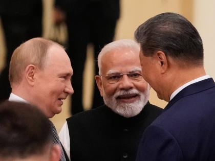
From left: President of Russia Vladimir Putin, Prime Minister of India Narendra Modi, and President of China Xi Jinping talk ahead of the Shanghai Cooperation Organisation  summit at the Meijiang Convention and Exhibition Center in Tianjin, China, on Mond