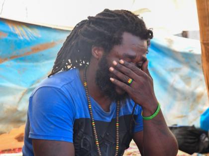 Jermaine Tomlinson sheds tears as he recounts his home being reduced to rubble and his efforts to save his family during Hurricane Melissa, in the community of Farm, Westmoreland.