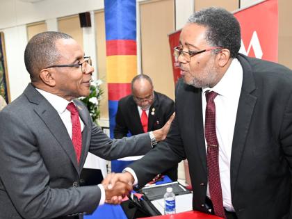 Professor Michael Taylor (right), dean of the Faculty of Science and Technology at the University of the West Indies (UWI) Mona, is greeted by Courtney Campbell, CEO of the VM Group, at the UWI MONA/VM GROUP Distinguished Lecture held on Thursday at the UW
