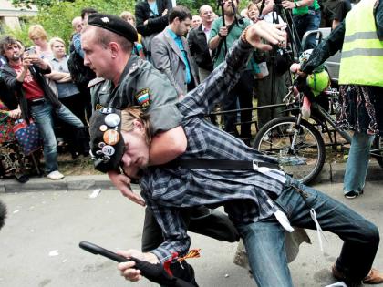 A police officer detains a supporter of the Russian punk group Pussy Riot outside a court in Moscow, Russia, Friday, August 17, 2012. A Moscow judge has sentenced each of the three members of the provocative punk band Pussy Riot to two years in prison on h