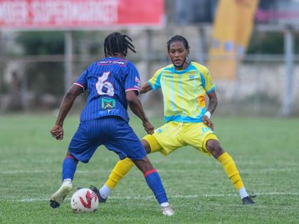 Spanish Town Police’s Shavan James (left) tries to take on Waterhouse’s Shamarie Dallas during a Jamaica Premier League match at the Anthony Spaulding Sports Complex yesterday. Spanish Town won the game 1-0.