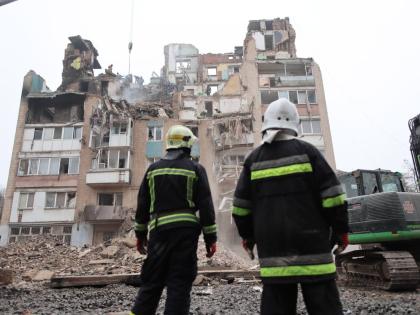 Rescue workers clear the rubble of a residential building which was heavily damaged by a Russian strike on Ternopil, Ukraine, Friday, November 21, 2025. 