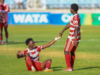 Glenmuir High School’s Tequaianne Allen is helped up by teammate Conroy Nicely during their ISSA daCosta Cup semi-final game against Dinthill Technical High School at Sabina Park yesterday. Glenmuir won 2-1.