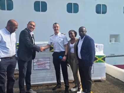Minister of Health and Wellness Dr Christopher Tufton (2nd left) greets Carnival Horizon Captain Nick De Ranieri (centre) during the handing over ceremony of 24 pallets of medical supplies for hurricane relief purposes at the Reynolds Pier in Ocho Rios, St