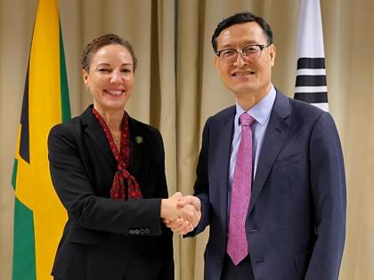 Foreign Affairs Minister Senator Kamina Johnson Smith (left) shakes hands with Kim Jin‑wook, Chargé d’Affaires at the Korean Embassy in Kingston.