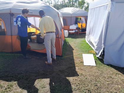 Americares Field Clinic team leader, John O’ Rourke (left), and Adwayne Beckford, parish manager for Hanover Health Services, view aspects of the field clinic facilities, which will be donated to the Ministry of Health and Wellness for future use.