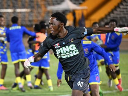 St Elizabeth Technical High School goalkeeper Jahnoi Steadman celebrates saving the penalty that gave his team an 8-7 sudden death penalty shootout win over Glenmuir High School in the ISSA daCosta Cup final at the National Stadium last night.